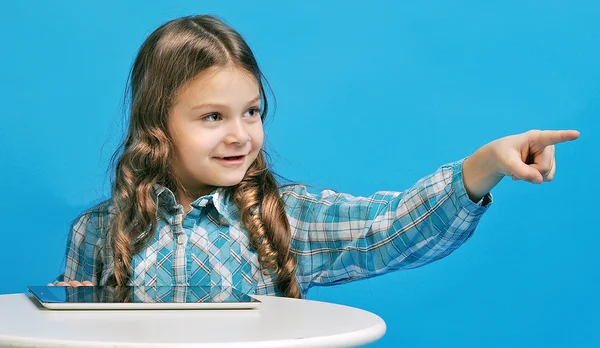 Caucasian little girl on a blue background — Stock Photo, Image