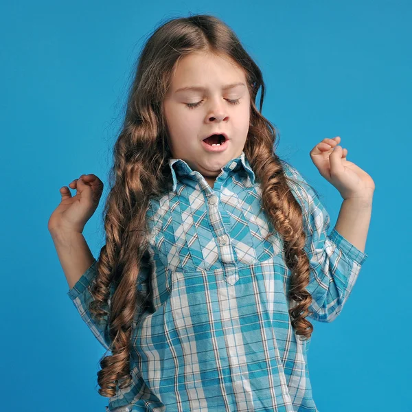 Caucasian little girl on a blue background — Stock Photo, Image