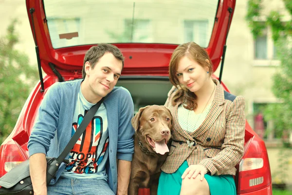 Happy young family with labrador — Stock Photo, Image