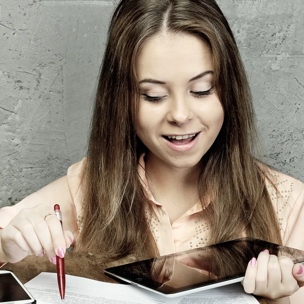 Young girl with a pen and the tablet — Stock Photo, Image