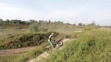 Ekstrem bir sporcu atladıktan sonra bisikletiyle uçar. Motosikletliler motokros pistinde, off-road 'a binip kum tepelerinin üzerinden atlıyorlar. Motokros için antrenman ve yarışma alanında sürüş.