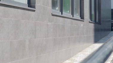 Tekerlekli sandalyeler, bisikletler ve binanın önünde çocuklu pusetler için paslanmaz çelik tırabzanlar olan bir rampa. Tekerlekli sandalye kaldırmak için tırabzan. Parlak paslanmaz çelik korkuluklar.