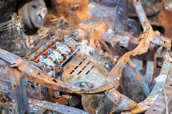 Broken and burned cars in the parking lot, accident or deliberate vandalism. Burnt car. Consequences of a car accident. Damaged by arson. Dump of civilian vehicles shot by Russian troops in Ukraine