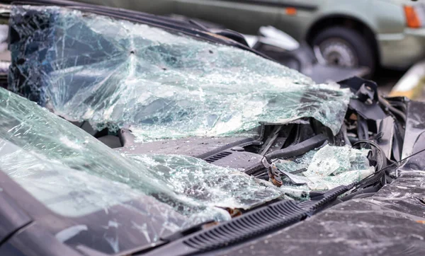Close-up of a car with a broken windshield after a fatal crash. Consequence of a fatal car accident. Automobile danger. Reckless dangerous driving. Vehicle after an accident with a pedestrian