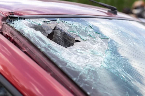 Close-up of a car with a broken windshield after a fatal crash. Consequence of a fatal car accident. Automobile danger. Reckless dangerous driving. Vehicle after an accident with a pedestrian