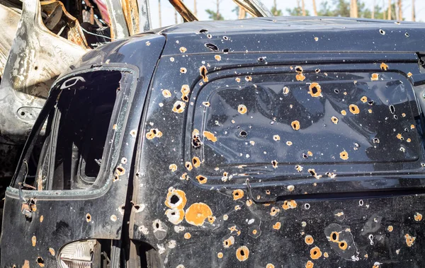 Shot, damaged cars during the war in Ukraine. The vehicle of civilians affected by the hands of the Russian military. Shrapnel and bullet holes in the body of the car. War of Russia against Ukraine