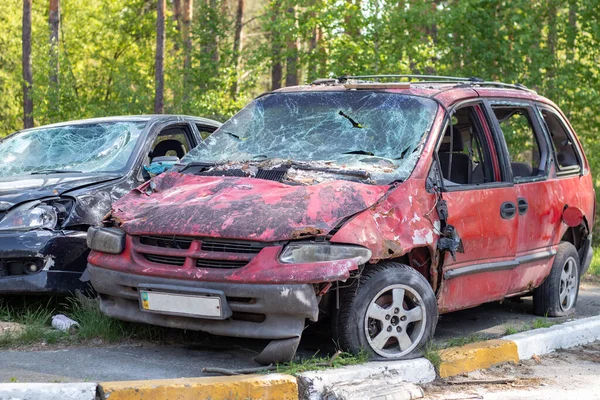Shot, damaged cars during the war in Ukraine. The vehicle of civilians affected by the hands of the Russian military. Shrapnel and bullet holes in the body of the car. War of Russia against Ukraine