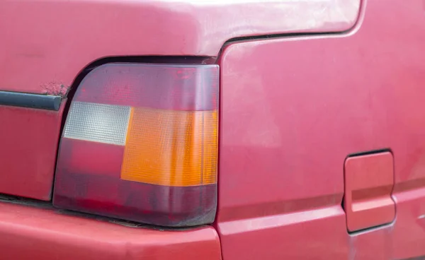 Lantern or reverse signal. The right taillight of a red classic retro car. The size of the Soviet-made machine. Light signal of white, red and orange, indicating the reverse of the car