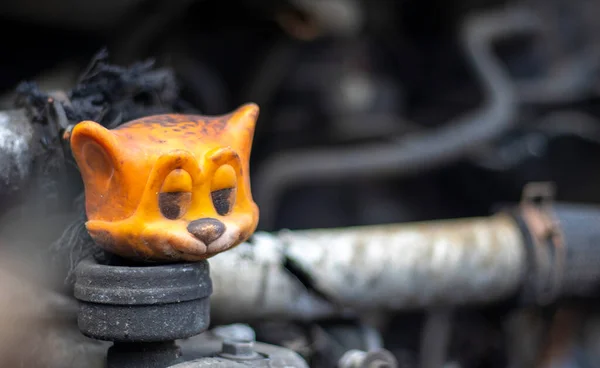 Broken car after a traffic accident. Auto insurance concept. Broken and damaged car. A toy in a burned-out car among spare parts and pipes