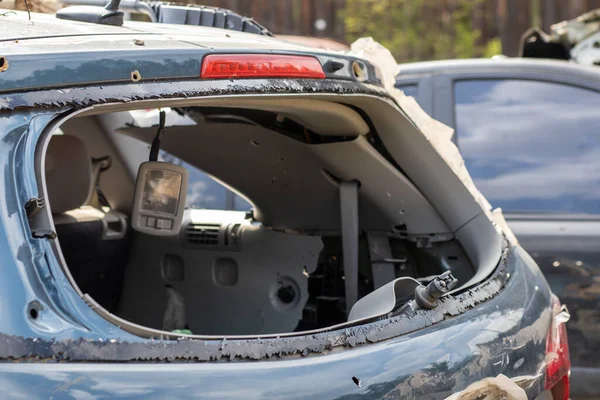 A car after an accident with a broken rear window. Broken window in a vehicle. The wreckage of the interior of a modern car after an accident, a detailed close-up view of the damaged car