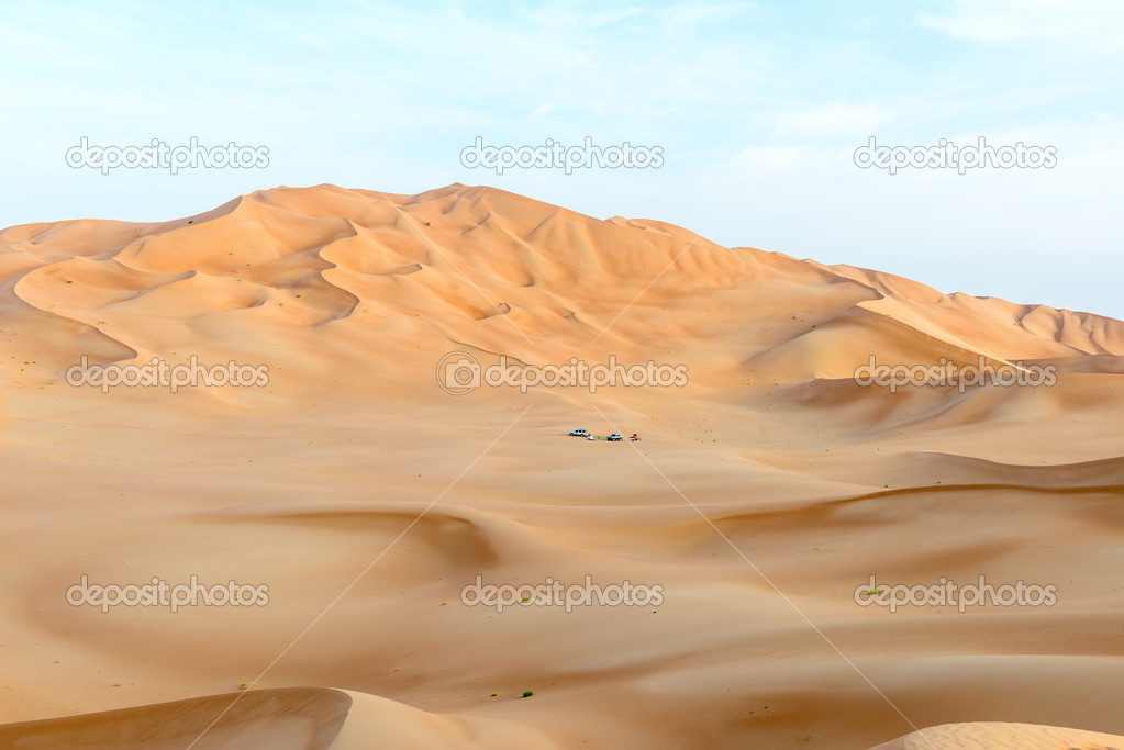People with tents and cars among dunes in Rub al-Khali desert (O
