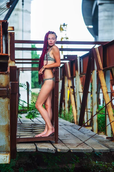 Giovane ragazza con le trecce e in costume da bagno a righe — Foto Stock