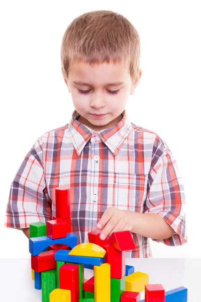 Boy playing wooden blocks — Stock Photo, Image