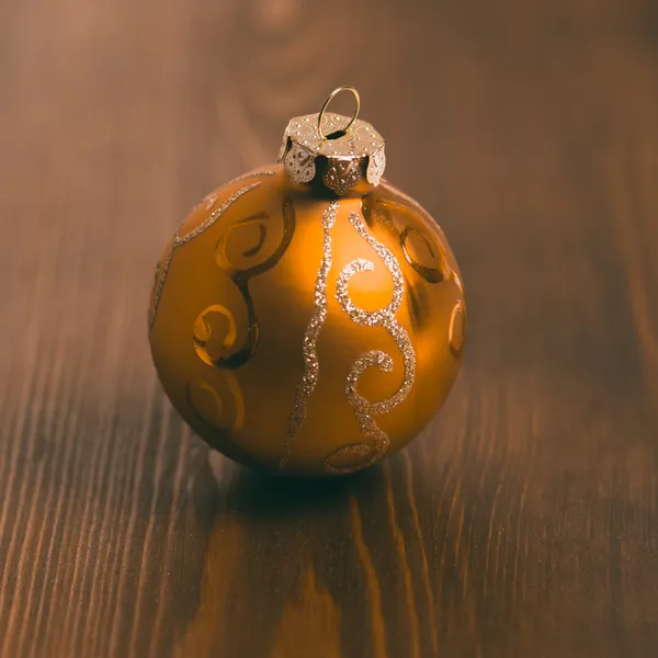 Golden Christmas ball on the floor. — Stock Photo, Image