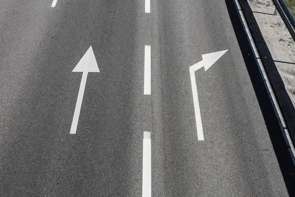 Arrows on asphalt showing traffic where to go — Stock Photo, Image