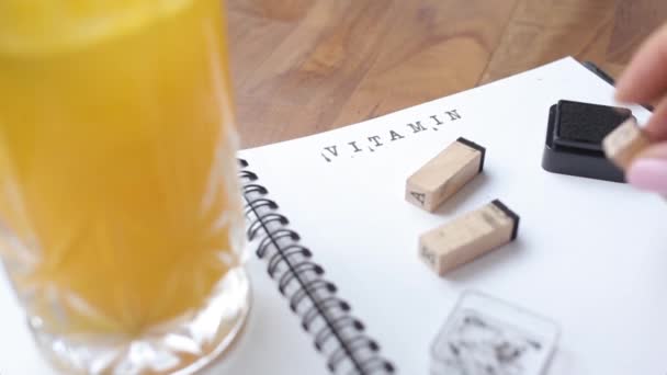 Stamp letters typing Vitamin C. Fresh orange juice — Stock Video