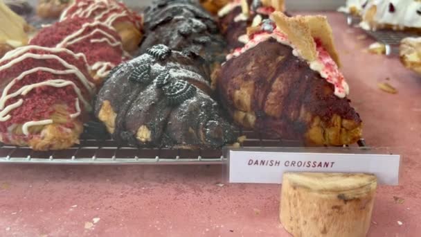 Läcker danich croissant med choklad topping och bär på displayen. Bageri skyltfönster. Söta bullar för gourmetälskare. — Stockvideo