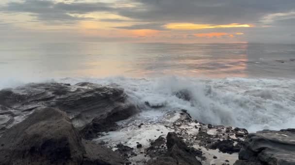 Powerful waves splashing on dark rocks at sunset. Ocean tide at dusk. Amazing dramatic landscape. Natural energy. — стоковое видео