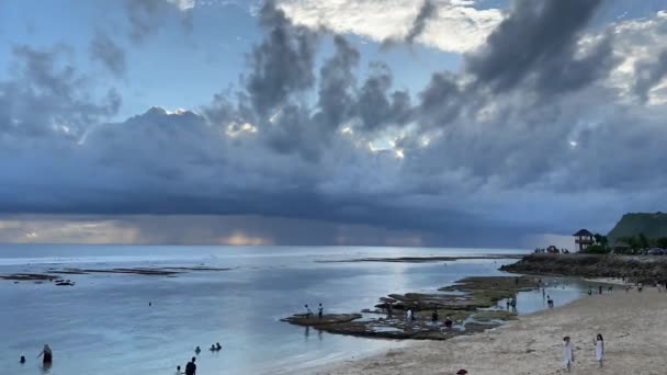 Timelapse av vackra grå storm moln kommer mot kameran ovanför havet rev och vit sand strand med massor av anonyma människor i tropiskt paradis. — Stockvideo