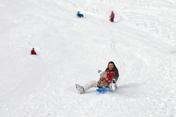 Mother with son, sliding don wthe hill — Stock Photo, Image