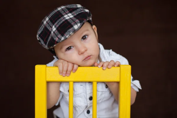 Garçon, assis sur une chaise — Photo