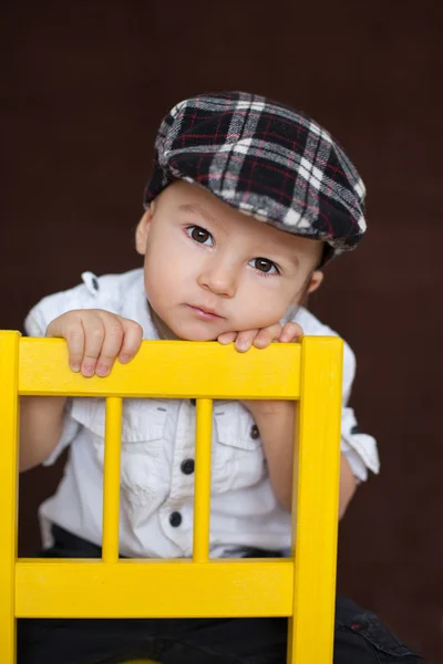 Boy, sitting on a chair — Stock Photo, Image