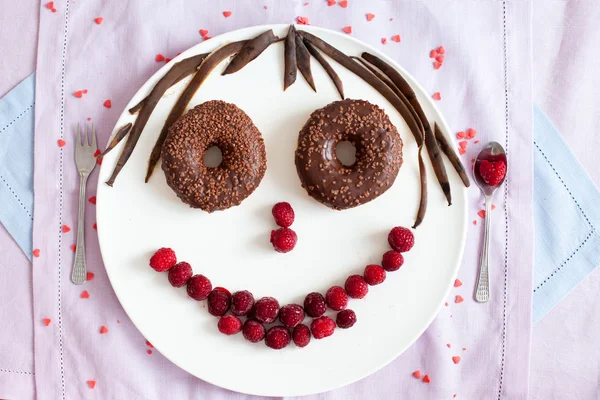 Chocolate donuts with raspberries — Stock Photo, Image