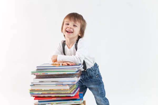 Boy with a pile of books — Stock Photo, Image