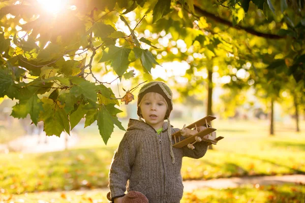 Little Toddler Child Boy Playing Airplane Knitted Teddy Bear Autumn — Stock Photo, Image