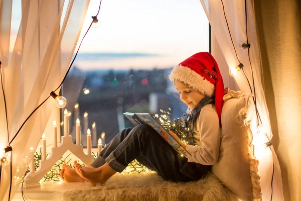 Toddler Child Cute Blond Boy Sitting Window Reading Book Christmas — стоковое фото