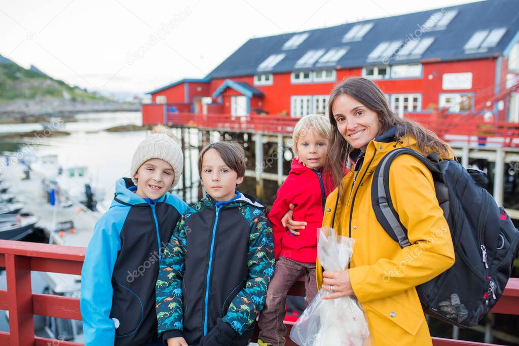 Family, enjoying walk in small A village on the end of Lofoten, northern Norway