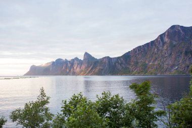 Happy family, standing on a rock and looking over Segla mountain on Senja island, North Norway. Amazing beautiful landscape and splendid nature in scandinavian country