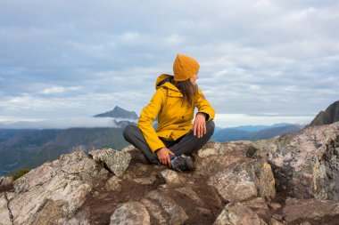 Happy family, standing on a rock and looking over Segla mountain on Senja island, North Norway. Amazing beautiful landscape and splendid nature in scandinavian country