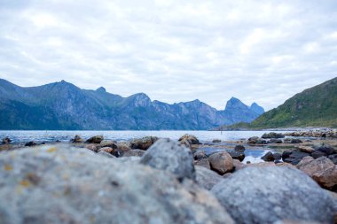 Happy family, standing on a rock and looking over Segla mountain on Senja island, North Norway. Amazing beautiful landscape and splendid nature in scandinavian country