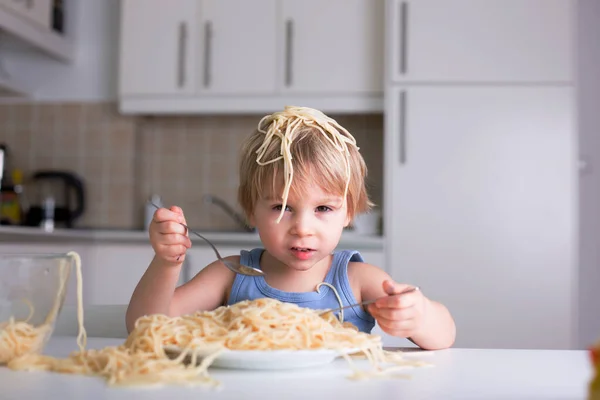 Little Blond Boy Toddler Child Eating Spaghetti Lunch Making Mess Stock Photo