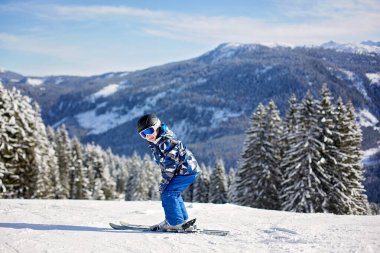Sevimli okul öncesi çocuk, Avusturyalı kış beldesinde bulutsuz bir günde, kış Kayak