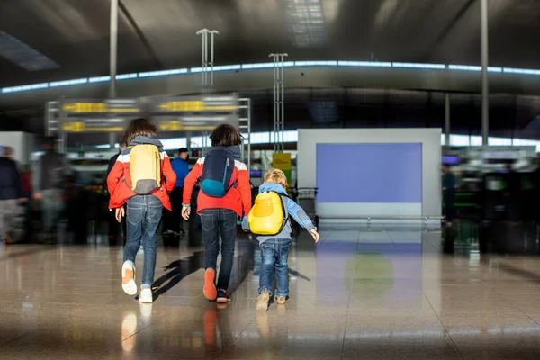 Kids, children, running late at the airport, people in a hurry to get to the plane for family vacation. Active family lifestyle travel by air with children on vacation