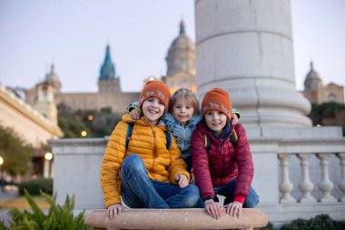 Üç çocuk, erkek kardeşler, Barselona, İspanya 'da gezinin tadını çıkarıyorlar.