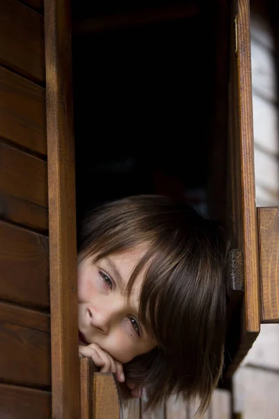 Preteen Boy Red Sweatshirt Hiding Wooden Door Looking Scared Sad — Stock Photo, Image
