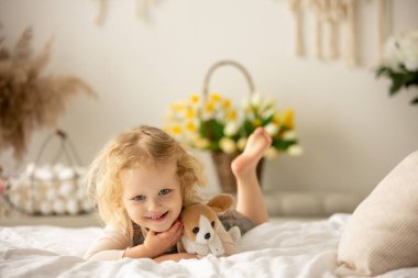 Happy children, siblings, enjoying Easter holiday together, tradition with handmade twig, braided whip made from pussy willow, traditional symbol of Czech Easter