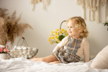 Happy children, siblings, enjoying Easter holiday together, tradition with handmade twig, braided whip made from pussy willow, traditional symbol of Czech Easter