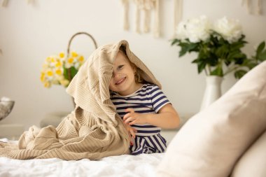 Happy children, siblings, enjoying Easter holiday together, tradition with handmade twig, braided whip made from pussy willow, traditional symbol of Czech Easter
