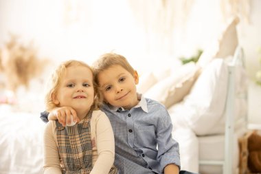 Happy children, siblings, enjoying Easter holiday together, tradition with handmade twig, braided whip made from pussy willow, traditional symbol of Czech Easter