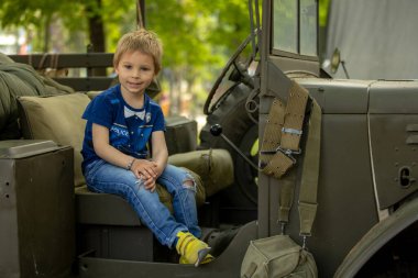 Toddler child, kid at military exhibition in Plsen, parade for the wirld war II
