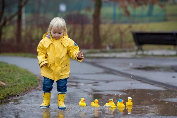 Beautiful Funny Blonde Toddler Boy Rubber Ducks Colorful Umbrella Jumping — Stok fotoğraf