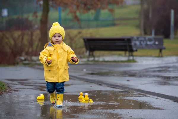 Beautiful Funny Blonde Toddler Boy Rubber Ducks Colorful Umbrella Jumping — Stockfoto