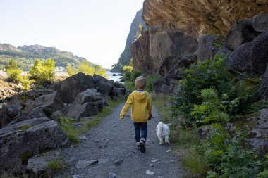 Happy people, enjoying amazing views in South Norway coastline, fjords, lakes, beautiful nature. Kids and adults traveling in Norway summertime