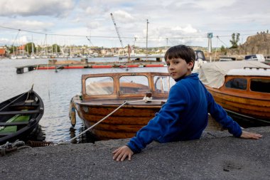 Beautiful town Kristiansand in Norway, family visiting Norway for summer vacation, kids enjoying amazing views