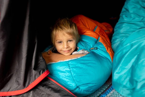 Children, sibilngs, sleeping in sleeping bags in a tent in Norway, wild camping