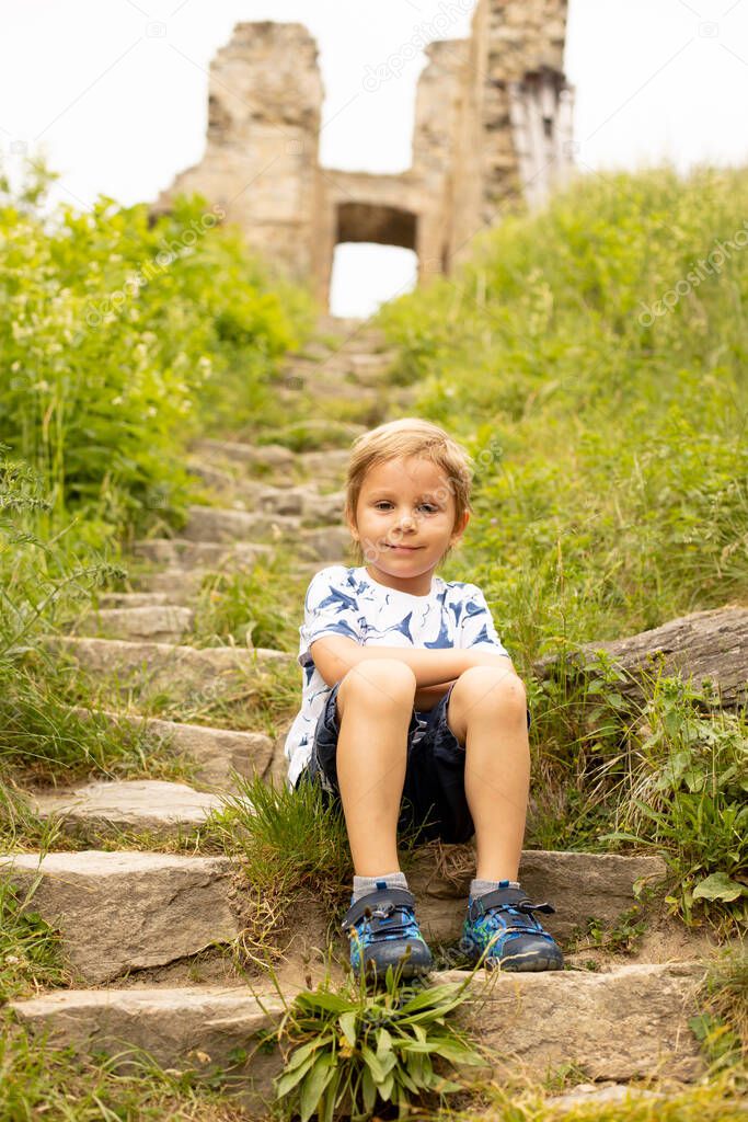 Child, visiting ruins Divci Kamen, Maiden Stone Castle in Czech Republic, near Ceske Budejovice